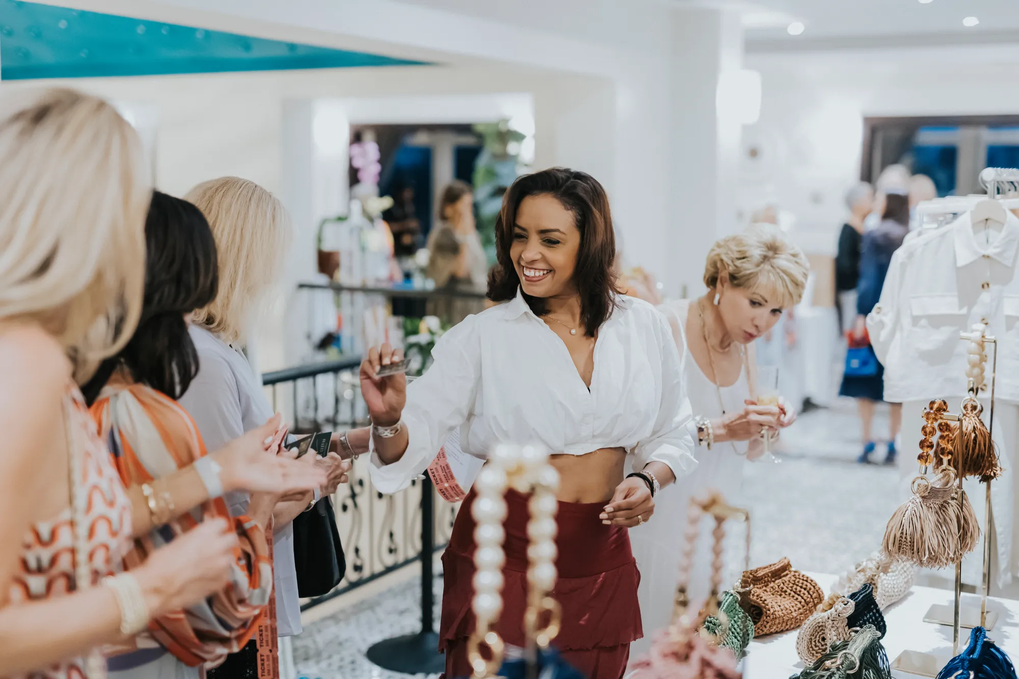 Indoor activity space with people browsing merchandise displays and decorative items on shelves.